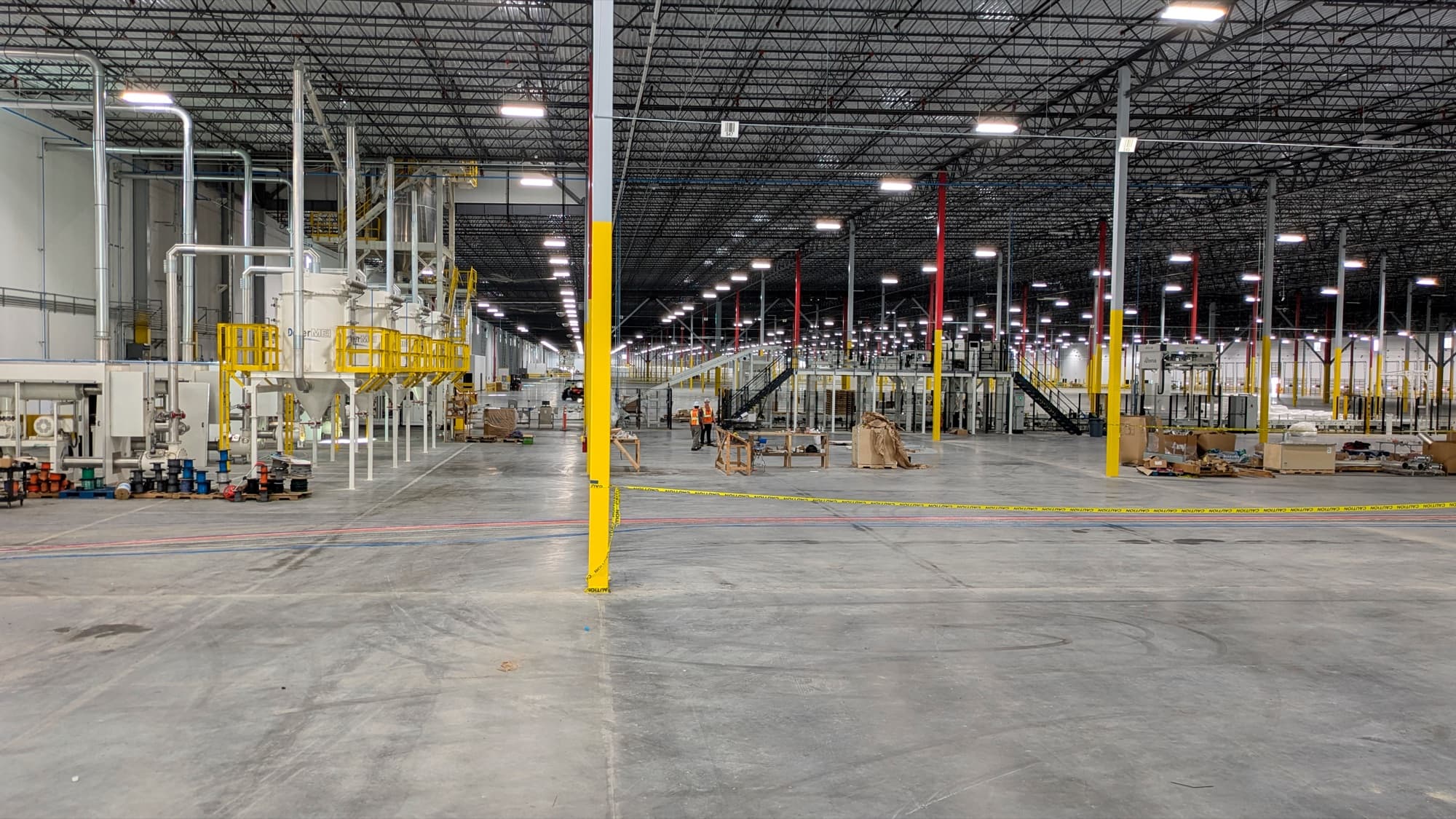 Warehouse interior during the network and low-voltage infrastructure build-out